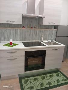 a kitchen with a sink and a stove at villa del mare in Nettuno