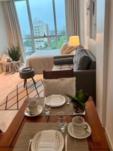 a living room with a table and a couch at Charlotte Belgrano Posadas in Posadas