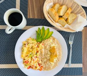 a plate of food with rice and bread and a cup of coffee at Casona 1530 in Tequila