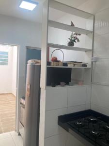 a kitchen with a refrigerator and a stove in it at Descanse perto do aeroporto e Conheça Maceió - 24h in Maceió +30 photos