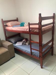 a couple of bunk beds in a room at Descanse perto do aeroporto e Conheça Maceió - 24h in Maceió