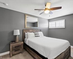 a bedroom with a bed and a ceiling fan at Dreamy Pool Home By Old Town, Sleep 14! in Scottsdale +35 photos