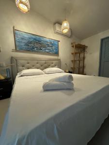a large white bed with two pillows on it at Playa Virginia Beach House Privada in San Silvestre