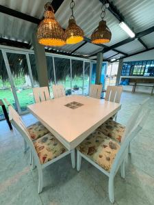 a dining room table with chairs and lights at Playa Virginia Beach House Privada in San Silvestre +16 photos