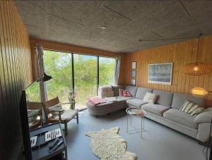 a living room with a couch and a table at 3398-Hvide-Sande-Anker-Eskildsens-Vej-100 in Hvide Sande