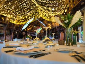 a table with a white table cloth with lights on it at Sofitel Kia Ora Moorea Beach Resort in Maharepa +172 photos