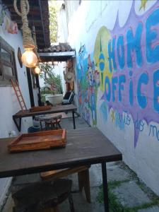 a room with two tables and a wall with a mural at Ganesha do mar in Búzios