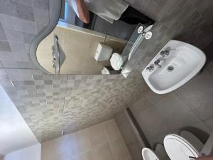 a bathroom with a sink and a mirror and a toilet at Quinta El Oasis Junin in Junín +19 photos