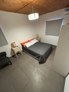 a bedroom with a bed and a chair in it at Quinta El Oasis Junin in Junín