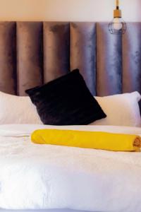 a yellow pillow sitting on top of a bed at Precious Guest House in Manamakgoteng