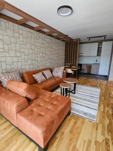 a living room with a couch and a table at Apartman A 210 Aparthotel Vucko Jahorina private host in Jahorina
