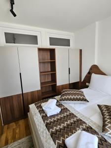 a bedroom with two beds and two windows at Apartman A 210 Aparthotel Vucko Jahorina private host in Jahorina