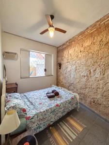 a bedroom with a bed and a ceiling fan at Casa Vix - Centro Histórico in Vitória
