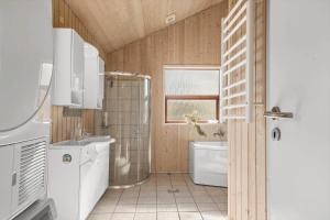 a bathroom with a shower and a toilet and a sink at OH490-Hadsund-Halvrebene-76 in Hadsund +17 photos