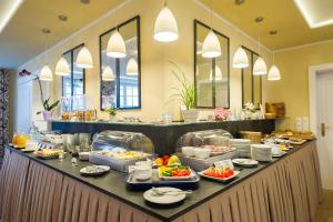 a buffet line in a hotel with food on it at Hotel Landhaus Ellerbrock in Böhl