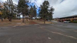 an empty road in front of a building with trees at Himont Motel in Fall River Mills +2 photos
