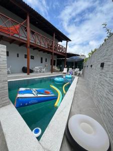 a swimming pool with a pool noodle in a house at Condominium Village V Praia dos Carneiros-PE in Tamandaré