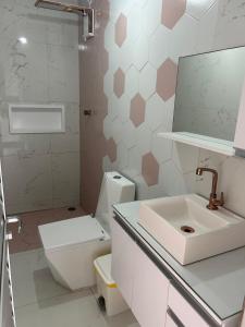 a bathroom with a toilet and a sink and a mirror at Casa de praia inteira pé na areia Maragogi in Maragogi +56 photos