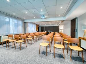 an empty room with chairs and a podium in a classroom at Mercure Paris 15 Porte de Versailles in Paris