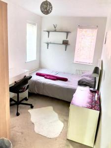a bedroom with a bed and a desk and a chair at Private room in BS14 in Bristol