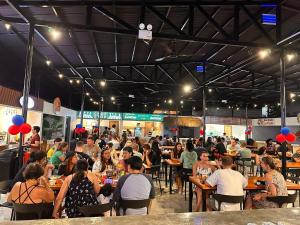 a crowd of people sitting at tables in a restaurant at HYD Hostel Moalboal in Moalboal