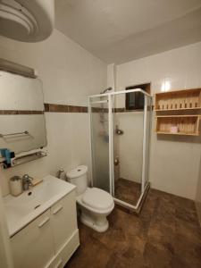 a bathroom with a shower and a toilet and a sink at Center appart chez ZENA in Dakar +25 photos