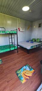 a room with two bunk beds and a wooden floor at Banana Bar in San Juan