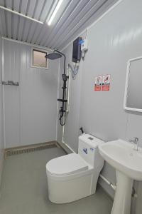 a bathroom with a toilet and a sink at Banana Bar in San Juan +12 photos