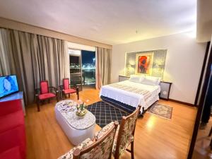 a hotel room with a bed and a table and chairs at Kubitschek Plaza Hotel - Flat Particular 4 - ALM Hospedagens in Brasília +17 photos