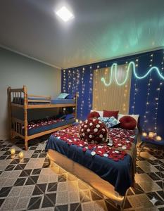 a room with two beds and a crib in it at Casa Luke Paraty in Paraty