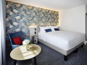 a hotel room with a bed and a table at Grand Hotel Bregenz - MGallery Collection in Bregenz +153 photos