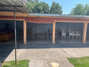 a pavilion with chairs and tables in it at Casa de descanso Emiliano in Salta