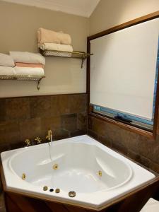 a large bath tub in a bathroom with a large window at The Haven  +29 photos