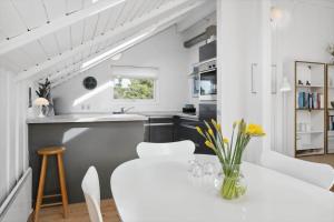 eine Küche und ein Esszimmer mit einem weißen Tisch und Stühlen in der Unterkunft 0206 Rømø - P S Carlsvej 22 in Tagholm