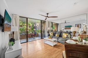 a living room with a couch and a table at Paki Maui 217 · PM 217 Cozy 1BR Oceanfront Condo w Pool in Lahaina