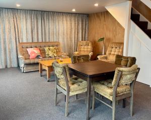 a dining room with a table and chairs at The Black Shed Studio in New Plymouth