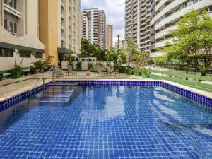 a large blue swimming pool in the middle of a building at ibis Fortaleza Praia de Iracema in Fortaleza