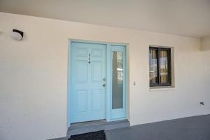 a blue door on the side of a building at Steps to Sand Ground Floor 2BR by Pool in Cocoa Beach +20 photos
