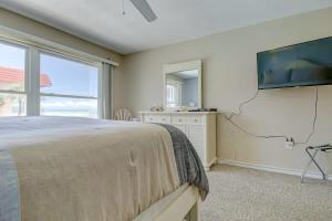 een slaapkamer met een bed en een flatscreen-tv bij Endless Blue Skies - 2 Bed 2 Bath in Cocoa Beach +26 foto's
