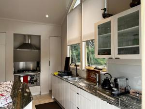 a kitchen with white cabinets and a counter top at The Haven 