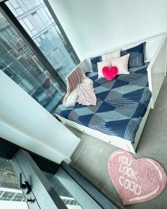 a room with a bed with pillows on it at 3415 - 2BR Luxury Suite #Free Car Parking# Retreat Near Crown in Melbourne +39 photos