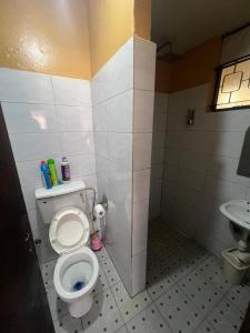a bathroom with a toilet and a sink at Bukoto pal in Kampala
