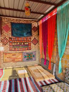 a room with two beds and colorful curtains at Hotel Muskan Heritage in Jaisalmer