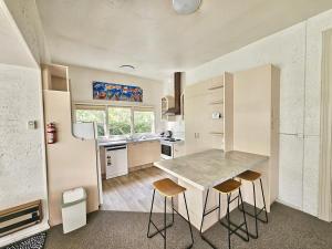 a kitchen with a table and chairs in a room at Cheltenham Villa in Hanmer Springs