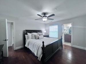 a bedroom with a bed with a ceiling fan at Destination #09 in Anaheim