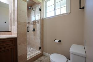 a bathroom with a shower with a toilet and a sink at Destination #19 in Anaheim +16 photos
