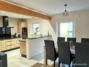 a kitchen and dining room with a table and chairs at Gîte spacieux à Thiel-sur-Acolin avec climatisation - FR-1-489-338 in Thiel-sur-Acolin