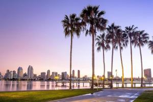 a group of palm trees next to a body of water at Modern Coastal Escape Breathtaking Ocean in Imperial Beach