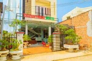 a building with a balcony with plants in front of it at Thanh Tran Guesthouse Lý Sơn in Ly Son