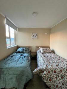 Ένα ή περισσότερα κρεβάτια σε δωμάτιο στο Departamento villarrica +7 φωτογραφίες